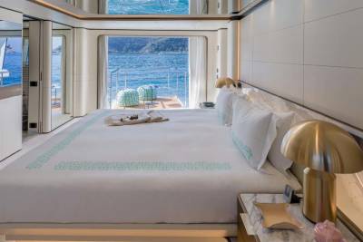 Wake up to breathtaking ocean views from this luxurious yacht bedroom with direct access to the deck.