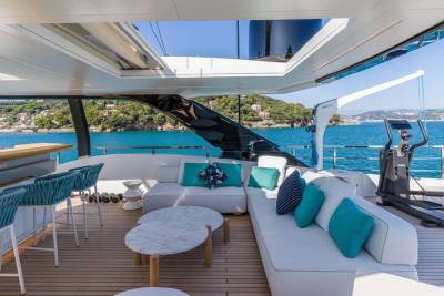 Relax on the deck of a luxurious yacht, enjoying the turquoise waters and Mediterranean coastline.