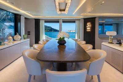 A luxurious yacht dining room offers stunning ocean views through expansive windows.