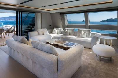 Luxurious yacht interiors seamlessly blend with breathtaking ocean views through expansive windows and open-air spaces.