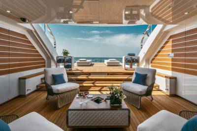 Relax in luxurious comfort on this yacht's expansive deck, with stunning ocean views and plush seating.