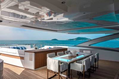 A luxurious yacht deck offers a serene dining experience with stunning ocean views and comfortable seating.