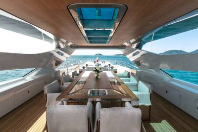 Luxurious yacht dining area offers stunning ocean views and comfortable seating for al fresco meals at sea.