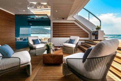 Relax in luxurious comfort on this yacht's deck, surrounded by stunning ocean views and elegant furnishings.