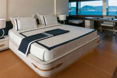 Luxurious yacht cabin offers a serene retreat with stunning ocean views and elegant furnishings.