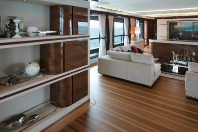 Luxurious yacht interiors feature sleek cabinetry, plush seating, and panoramic ocean views.