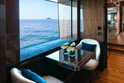 Luxurious yacht interiors offer stunning ocean views from intimate seating areas.