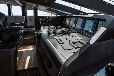 The sleek, modern bridge of a luxury yacht offers advanced navigation displays and comfortable seating for the captain.