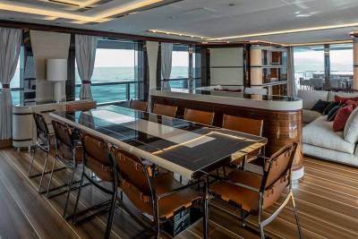 Luxurious yacht interiors offer breathtaking ocean views from a sophisticated dining area and plush lounge.