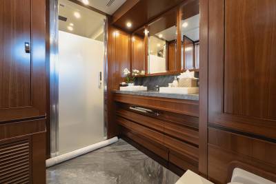 Luxurious wood cabinetry and marble floors create a spa-like ambiance in this elegant yacht bathroom.