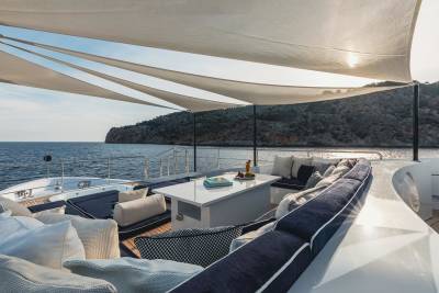 Relax on the luxurious deck of a yacht, enjoying the serene ocean views and a refreshing drink.