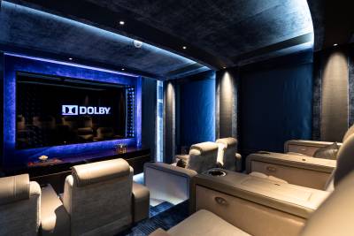 Luxurious home theater seating awaits in this Dolby Atmos-equipped private cinema.