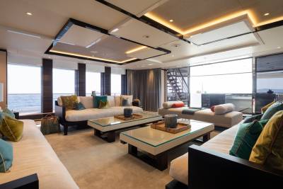 Luxurious yacht interiors offer plush seating and stunning ocean views through expansive windows.