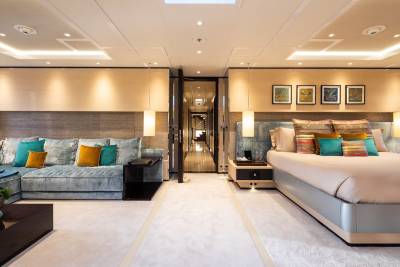Luxurious yacht accommodations feature a spacious living area and a comfortable master suite with elegant decor.