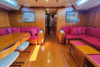 Luxurious yacht interiors feature plush seating and rich wood paneling, creating an elegant and inviting atmosphere.