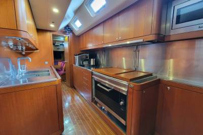 The polished wood and stainless steel of this yacht's galley create a sleek and functional space for preparing meals at sea.