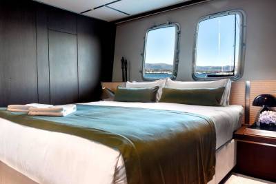 Wake up to stunning ocean views from this luxurious yacht cabin, complete with plush bedding and modern amenities.
