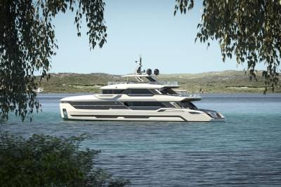 A sleek, modern yacht glides through tranquil turquoise waters, framed by lush green foliage.