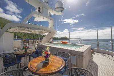 Relax in the onboard jacuzzi while taking in the stunning ocean views from this luxurious yacht deck.
