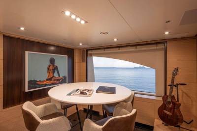 A cozy dining area with a view of the ocean offers a perfect spot to relax with a guitar and a good read.