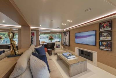 Relax in the luxurious living area of this yacht, featuring contemporary art and stunning waterfront views.