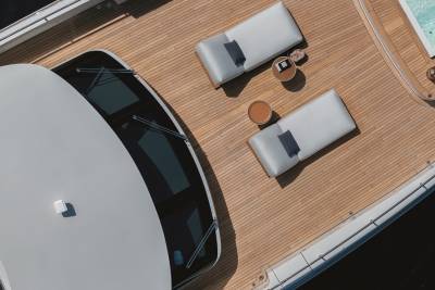Relax on the sun-drenched deck of this luxurious yacht, complete with comfortable loungers and a refreshing hot tub.