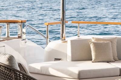 Relax on the plush outdoor seating of this luxury yacht while the ocean waves gently lap against the hull.