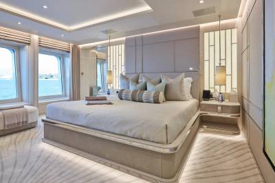 Luxurious yacht bedroom offers serene ocean views and elegant, modern design.