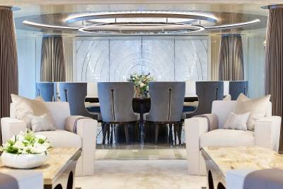 Elegant dining chairs and plush armchairs create a luxurious seating arrangement in this sophisticated interior.