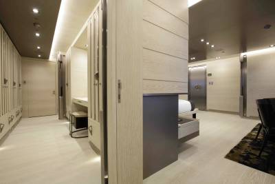Luxurious wood-paneled interiors create a serene and sophisticated atmosphere, hinting at exclusive accommodations.