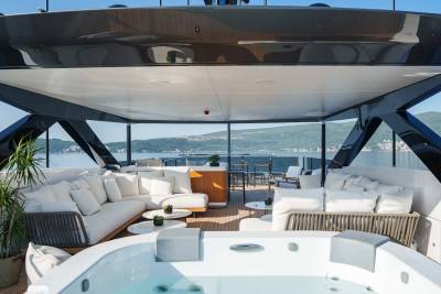Relax in the luxurious jacuzzi on this yacht's deck, surrounded by plush seating and stunning ocean views.