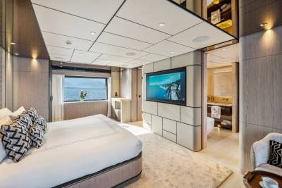 Luxurious yacht bedroom offers stunning sea views and a sleek, modern design with an en-suite bathroom.