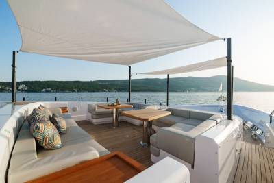 Luxurious yacht seating and dining areas offer a perfect spot to enjoy the serene coastal views.