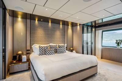 Luxurious yacht bedroom offers stunning ocean views and elegant, modern design.