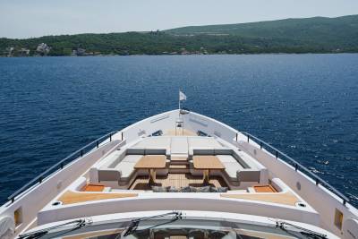 Luxurious yacht seating and tables offer a prime spot for enjoying the sun-drenched Mediterranean waters.