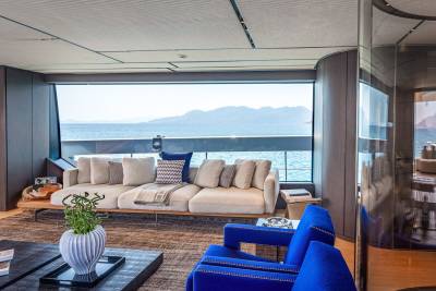 Luxurious yacht interiors offer breathtaking ocean views through expansive windows.