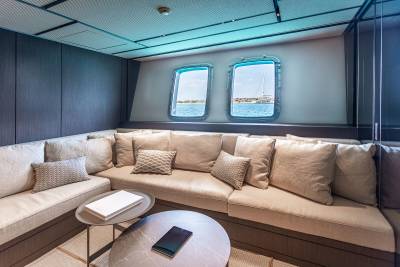 Relax in this cozy lounge area with ocean views through the porthole windows.