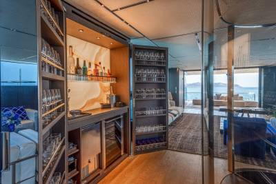 A well-stocked bar with a stunning ocean view awaits guests on this luxurious yacht.