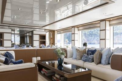 Luxurious yacht interiors offer stunning ocean views through large windows, creating a serene and elegant atmosphere.