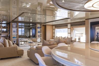 Luxurious yacht interiors feature plush seating, elegant decor, and expansive windows overlooking the water.