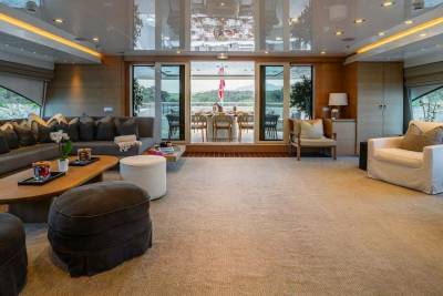 Luxurious yacht interiors offer a serene escape with plush seating and panoramic views of the stunning coastline.