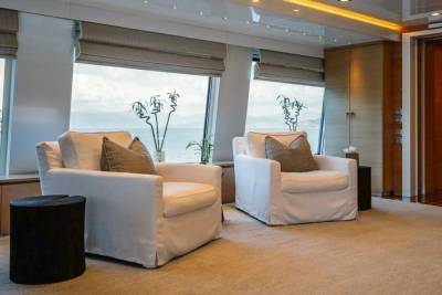 Relax in plush armchairs with stunning ocean views from the comfort of this luxurious yacht salon.