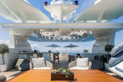 Relax on the luxurious deck of this yacht, complete with plush seating, a hot tub, and stunning ocean views.