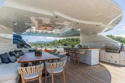 Enjoy al fresco dining and grilling on the spacious deck of this luxurious yacht, surrounded by stunning natural scenery.