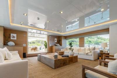 Luxurious yacht interiors blend natural wood tones with crisp white furnishings for a serene and elegant ambiance.
