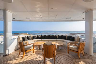Relax on the spacious deck of this luxury yacht, enjoying the serene ocean views from comfortable seating.