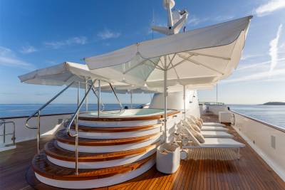 Relax in the sun-drenched jacuzzi on the deck of this luxurious yacht, surrounded by the sparkling blue sea.