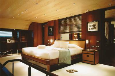 Luxurious wood paneling and plush bedding create a serene retreat aboard this elegant yacht.