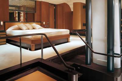Luxurious wooden interiors and a plush king-sized bed create an opulent retreat on this yacht.
