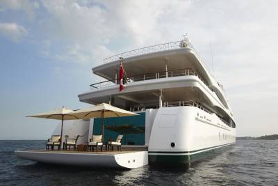 The luxurious Lady Christine yacht offers a serene deck with comfortable seating and umbrellas for ultimate relaxation at sea.